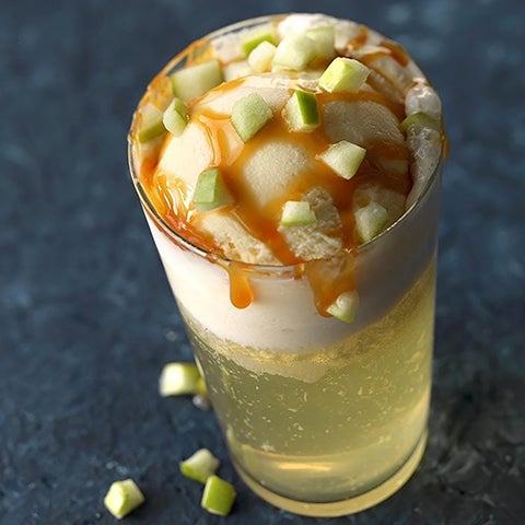 a glass filled with icecream and juice