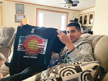 David holding a shirt up