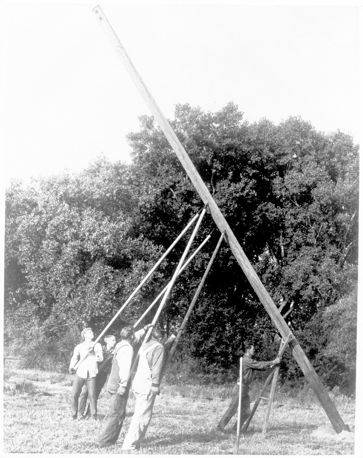 In the early days of electric co-ops, utility poles were put in place by hand – and a lot of hard work! Photo courtesy of NRECA