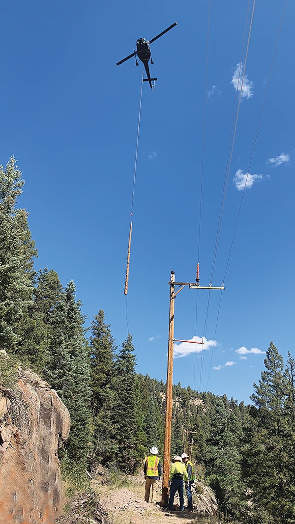 Helicopter carrying electric pole