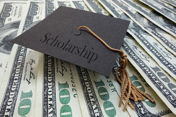scholarship text with cash and grad cap